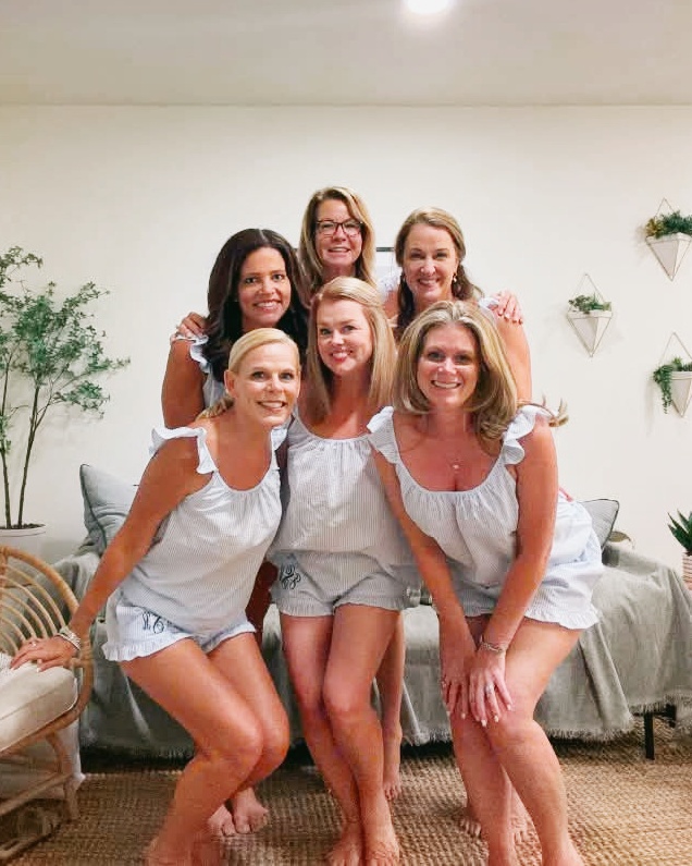 Six friends wearing coordinated blue striped looks on a girls weekend